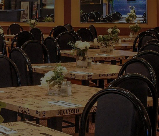 image of tables and chairs from the inside of Station Pizza.