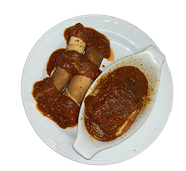 half the plate holds a lasagna bowl with a single slice of meat lasgana topped with homemade tomato sauce and the other half has two homemade manicottis stuffed with ricotta, mozzeralla rolled in a homemade crepe and topped with homemade tomato sauce.