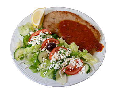 half the plate with a breaded veal cutlet topped with tomato sauce, and the other half with a greek salad with sliced tomato wedges, sliced onion, sliced cucumbers, on top of a green lettuce, with black olives, feta cheese and topped with homemade Greek Dressing and a wedge of lemon